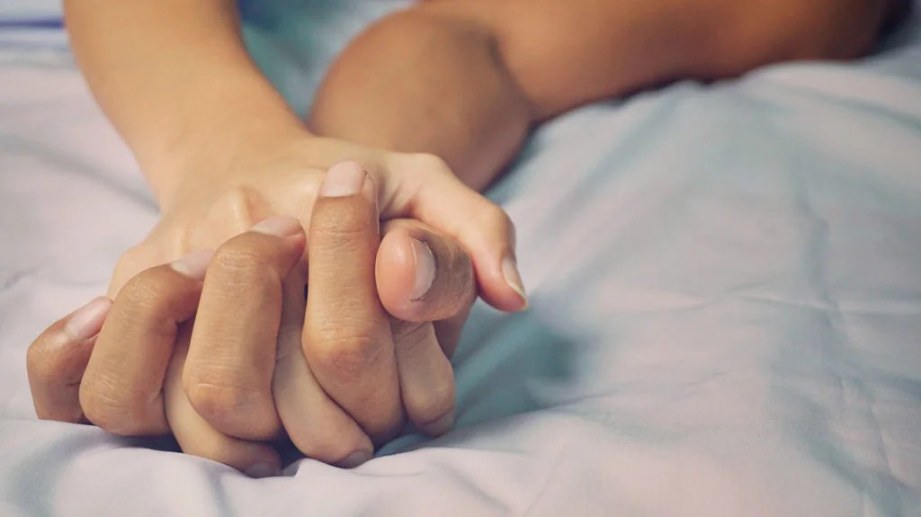 hands being held in bed